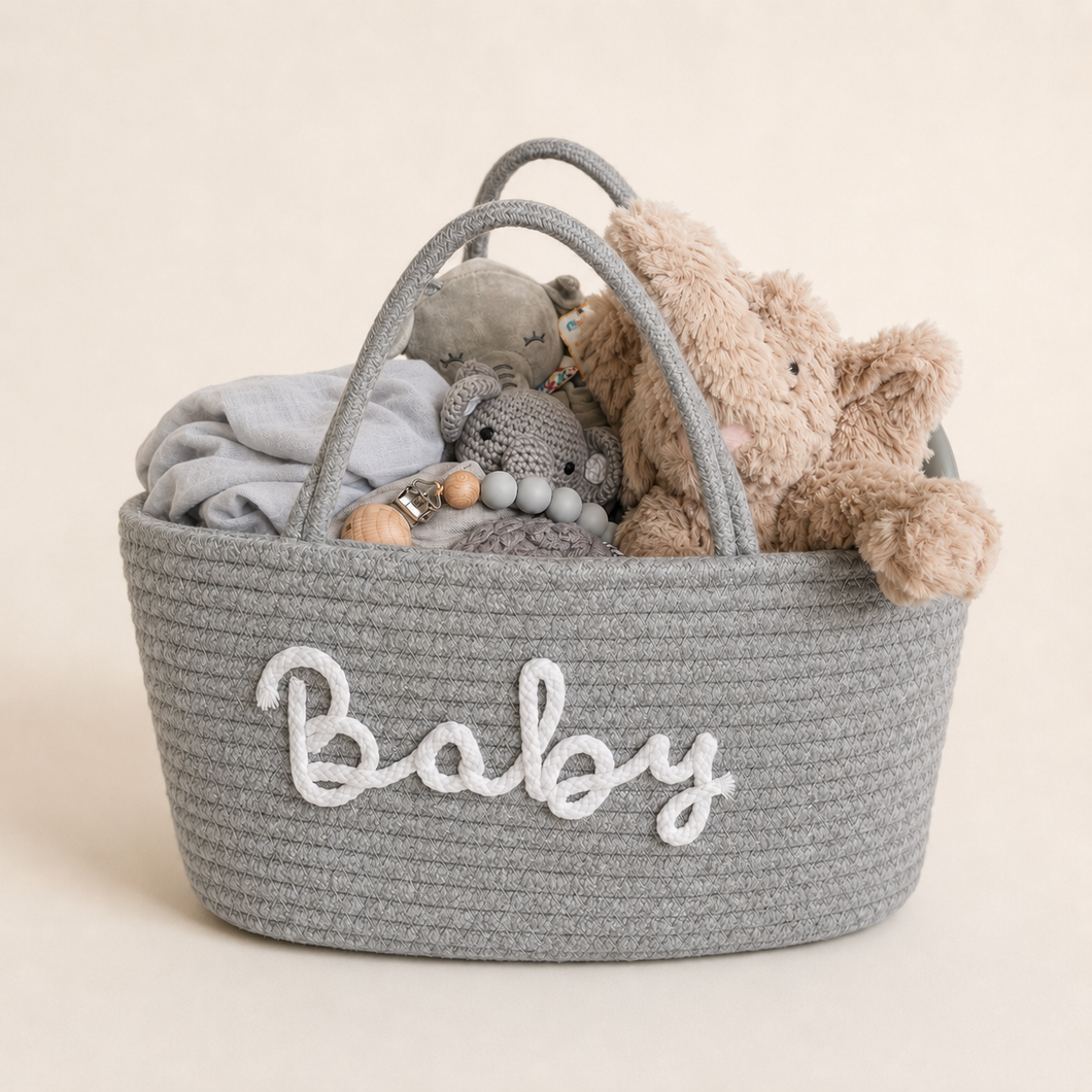 Hand-arranged Baby Elephant Deluxe gift presented inside a grey rope nursery basket.