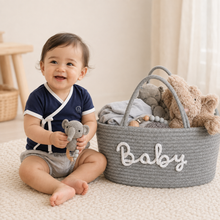 Baby wearing a navy Lovingly Organics Samurai Tee beside the Baby Elephant Deluxe Basket.