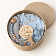 Open round kraft baby boy gift box with blue Samurai Tee, grey swaddle, teethers, pacifier chain and Hello World disc