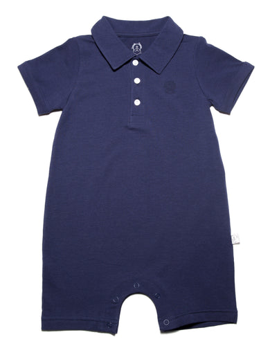 Solid Navy Blue 3 button polo shirt cut short leg onesie with smart short sleeves with a roll up detail. Sharp structured collar and total ease in our organic cotton super soft one piece baby onesie for toddlers. Our lovingly organics logo is embroidered in tonal color for a descrete logo on right side upper chest area.