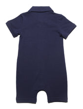 back side view of Navy blue dark  solid short leggs  onesie with  white collar and a smart pocket on the chest, short sleeves with roll up detail and full snap button closure. Really smart clean and classic looking in soft organic cotton.