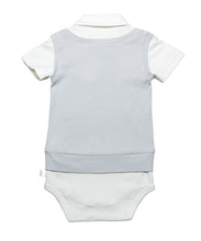 Back side view of White short sleeve onesie with snap buttons between the legs, short sleeves and a smart collar.  Light grey mock sweater vest on top wth a snap tie at the neck shows a complete outfit that is waiting for your favorite bottoms. Soft organic cotton and a polished finished look. 